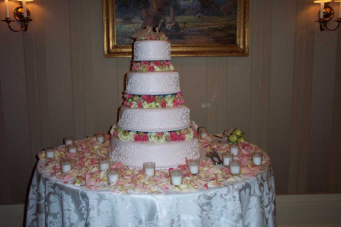 Cake table ideasred roses and white candles and silver letters that say 